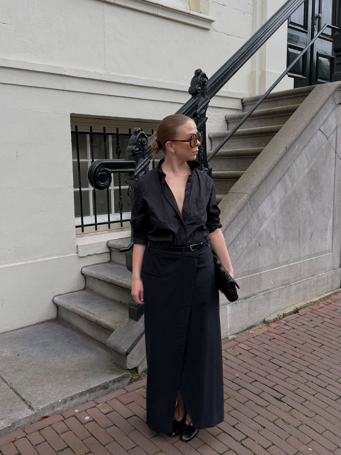 影響者 Dina Hansen 穿著亞麻襯衫、柱裙和超大太陽眼鏡。